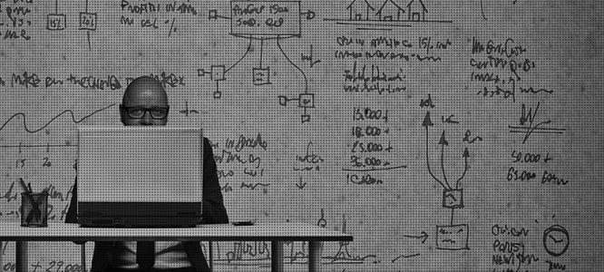 kenneth arendt jensen at a desk with project blueprints on the wall behind me